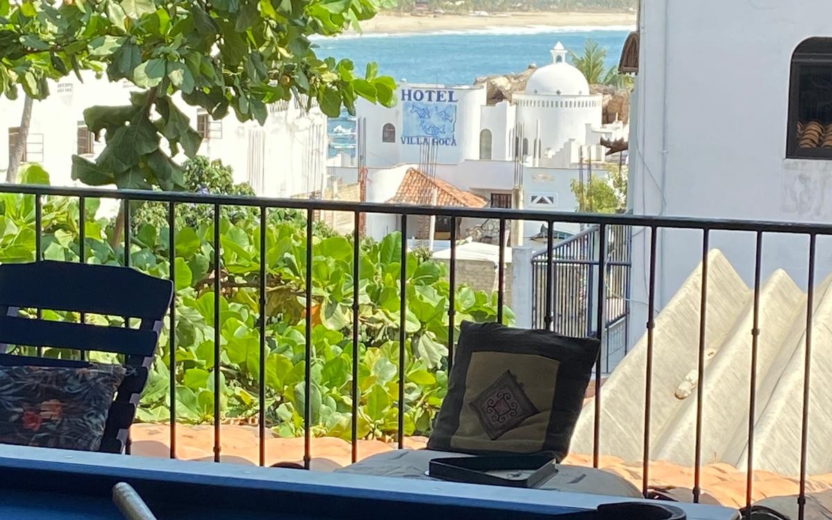 Open terrace at MayFlower Hotel & Hostal with the pool table, looking over the rooftops toward the sea